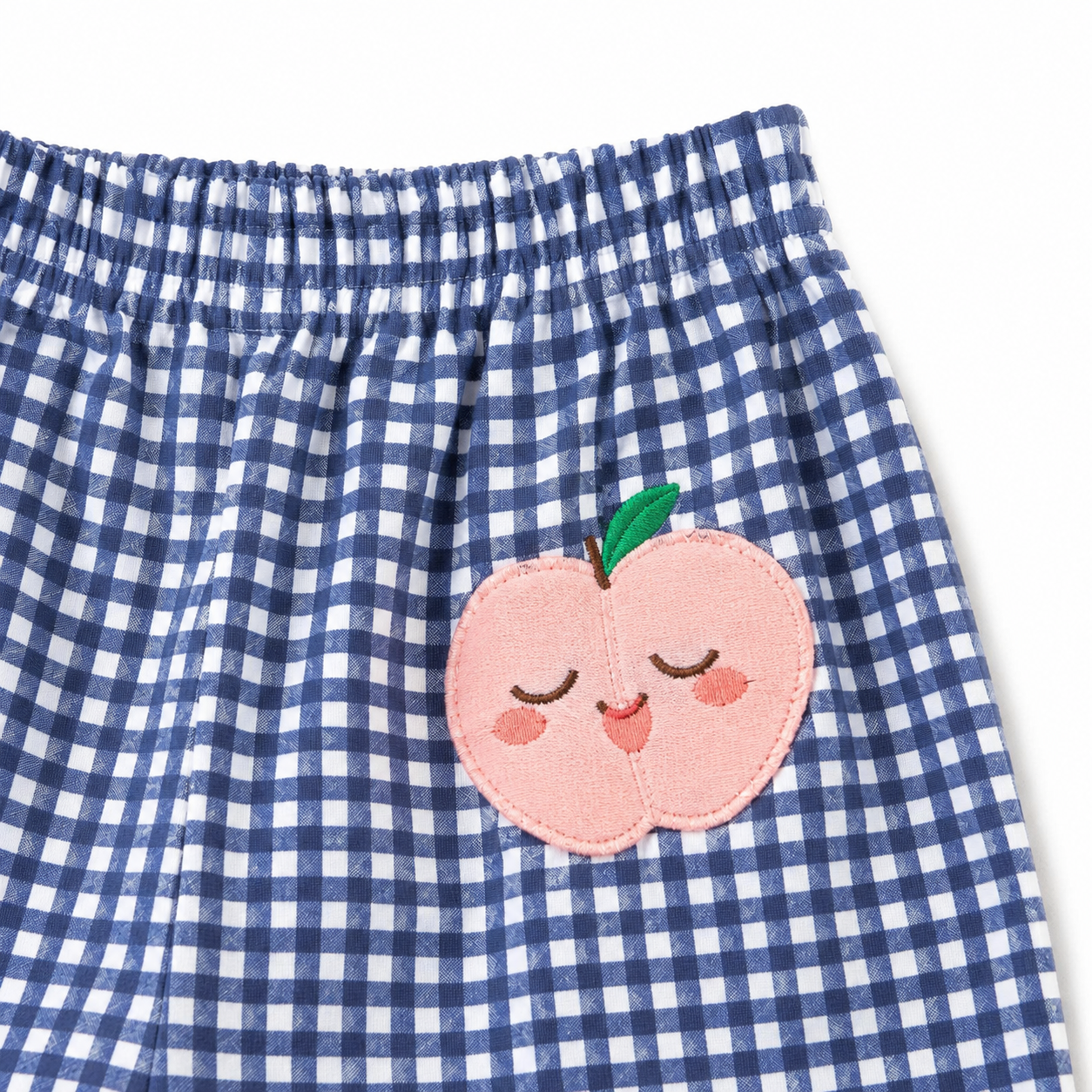 Blue gingham girls pants peach patch close-up