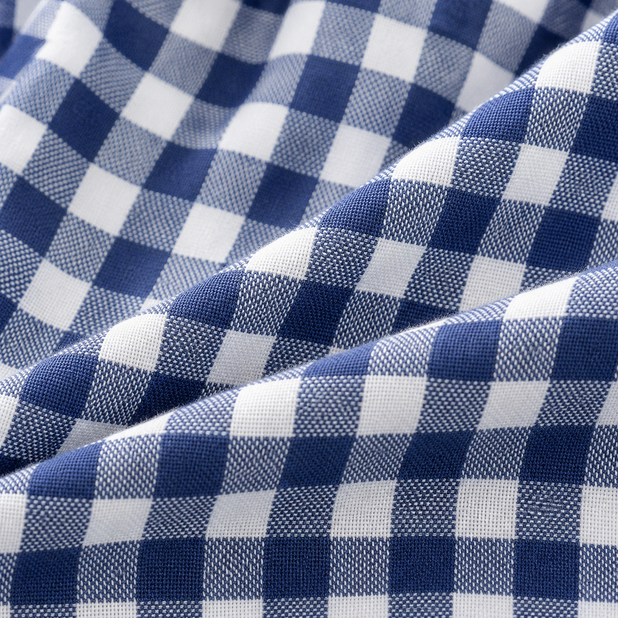 Blue and white gingham cotton fabric close-up on girls pants
