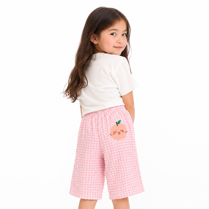 Girl model wearing pink gingham cotton pants with peach patch