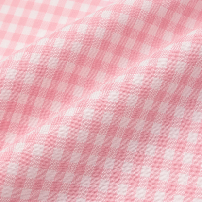Pink and white gingham cotton fabric close-up on girls pants