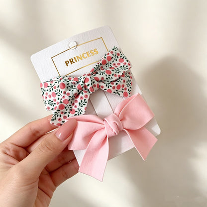 Petal Bloom Bow Clip Set with berry floral bow and soft pink bow clips.