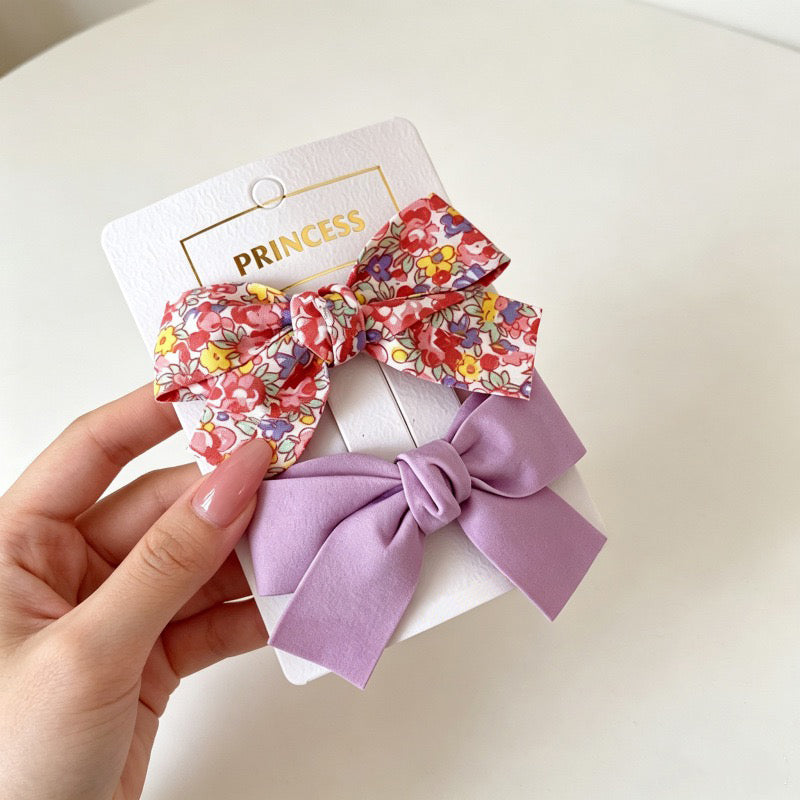 Petal Bloom Bow Clip Set with red floral bow and lavender bow hair clips.