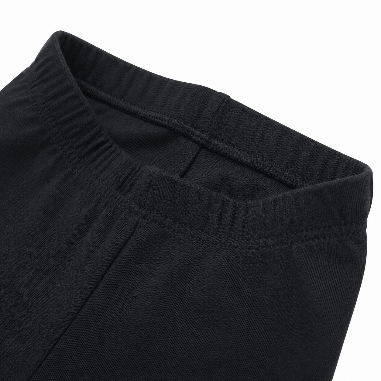 Close-up of the cotton fabric and seam detail on the black leggings.