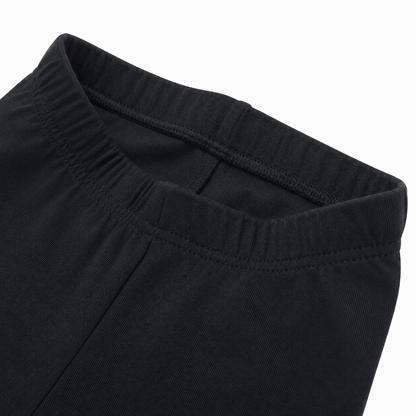 Close-up of the cotton fabric and seam detail on the black leggings.
