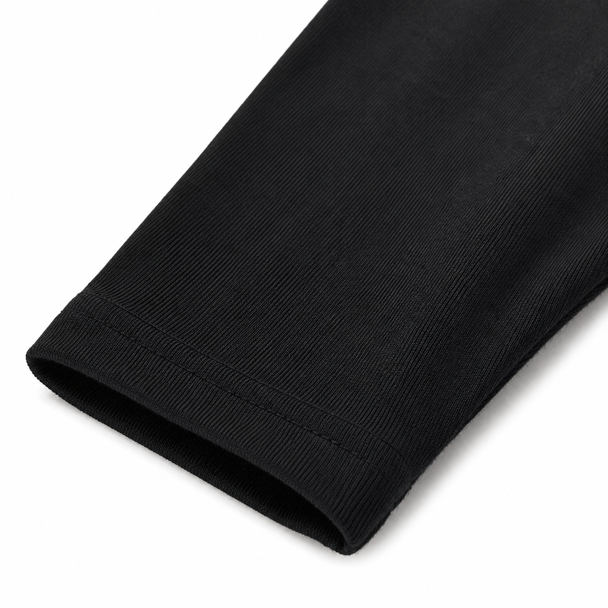 Close-up of the ankle hem and cotton fabric on the black girls leggings.