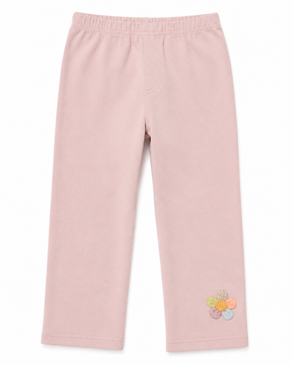 Front flat lay of the blush pink girls cotton leggings with small flower detail near the hem.