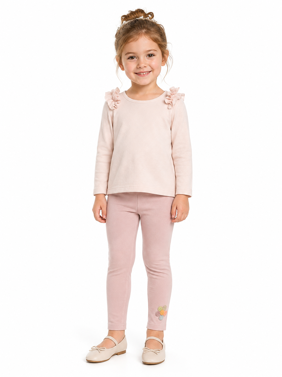 Girl model wearing the blush pink cotton leggings with a small flower detail near the ankle.