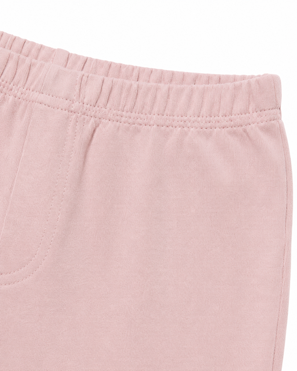 Close-up of the cotton fabric and seam detail on the blush pink leggings.