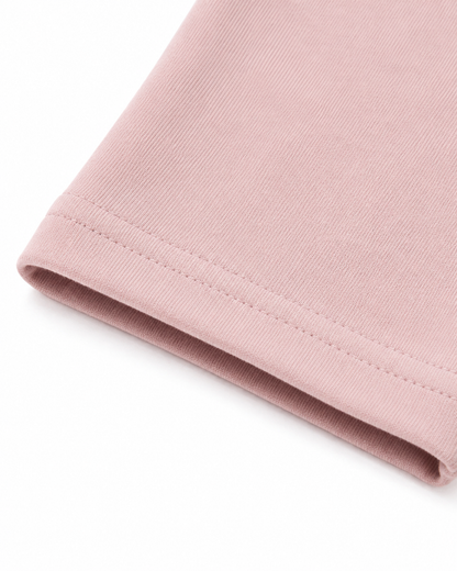 Close-up of the ankle hem and cotton fabric on the blush pink girls leggings.