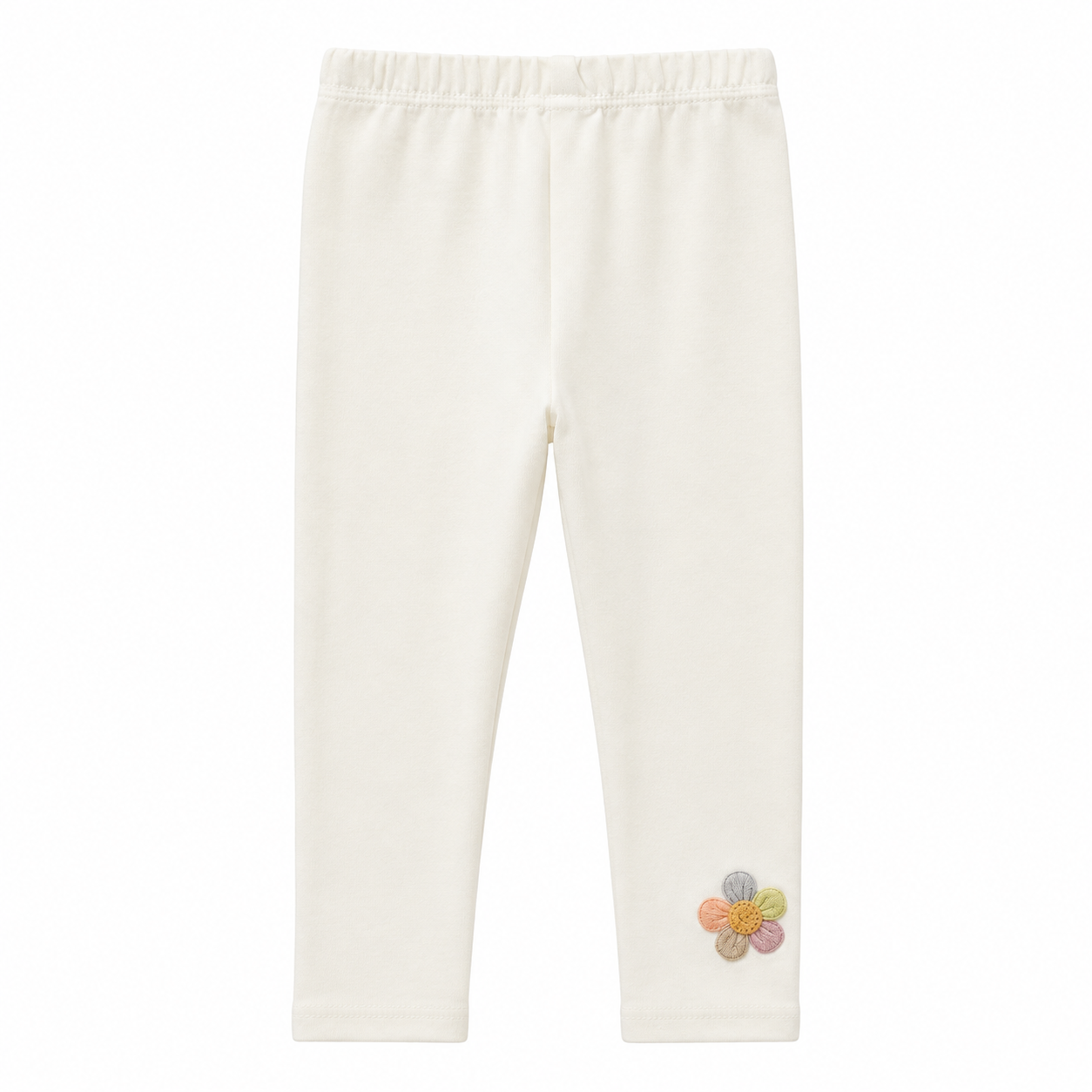 Front flat lay of the ivory girls cotton leggings with small flower detail near the hem.