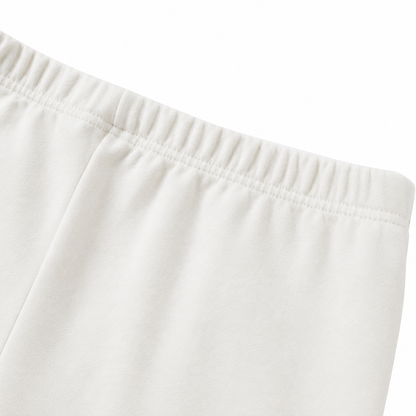 Close-up of the cotton fabric and seam detail on the ivory leggings.