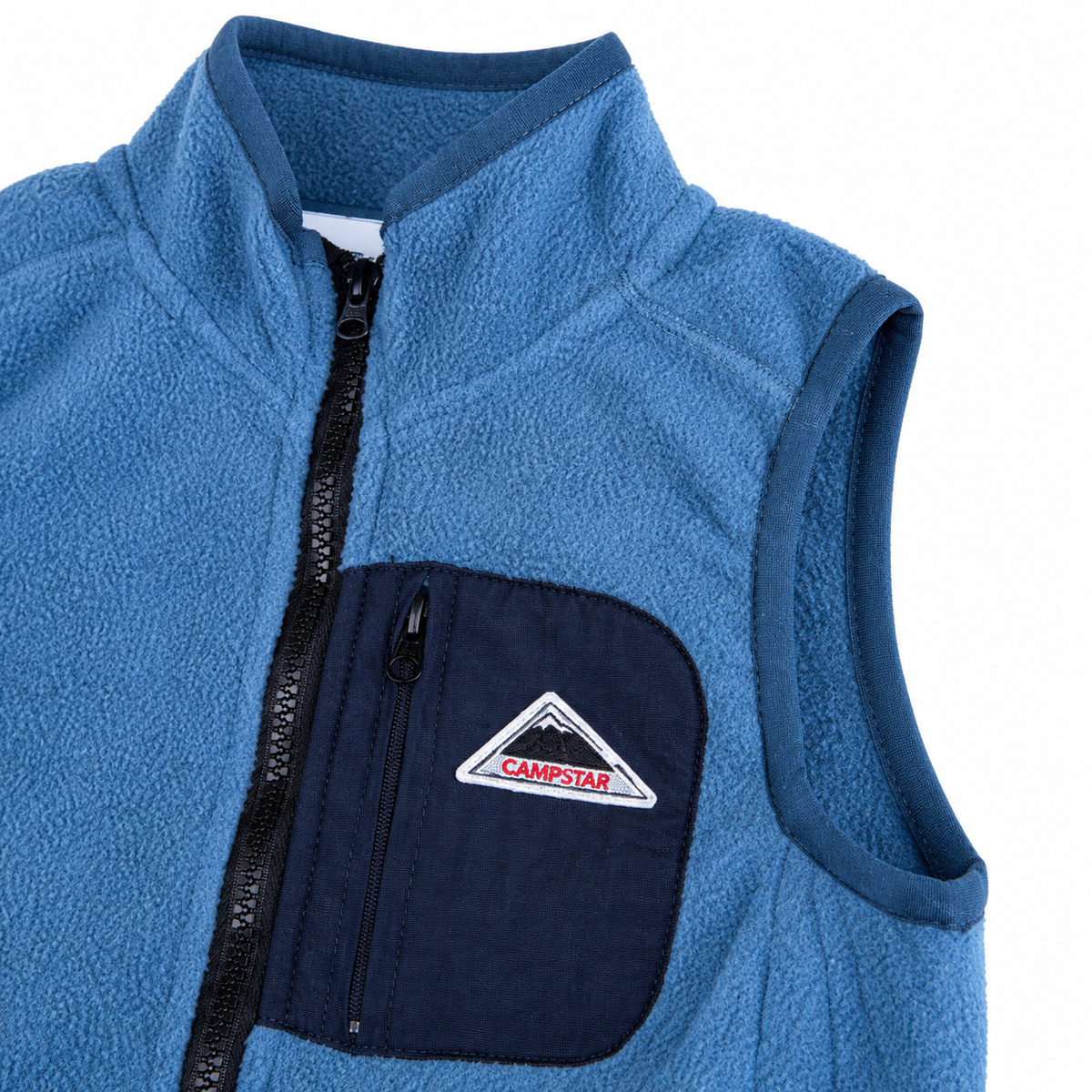 Close-up of the armhole binding and contrast navy chest pocket on the blue fleece vest.