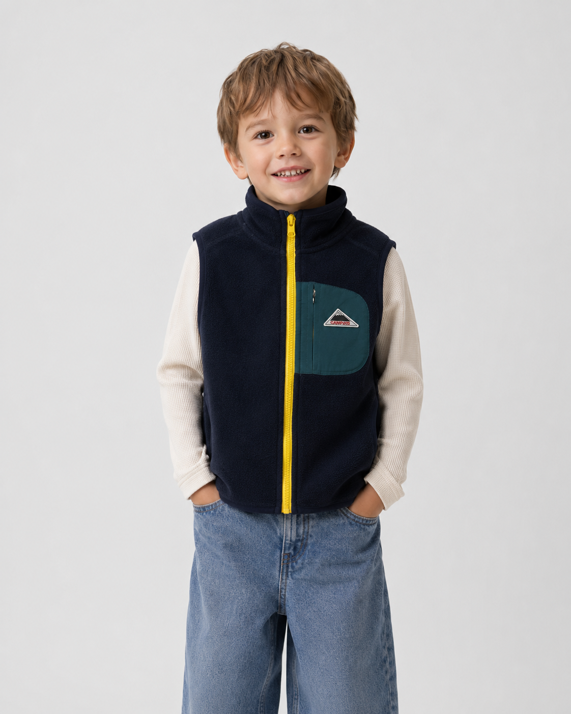 Boy model wearing the navy teal fleece zip vest.