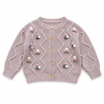 Front flat lay of the dusty mauve girls cable knit cardigan with colorful pom blossom details.