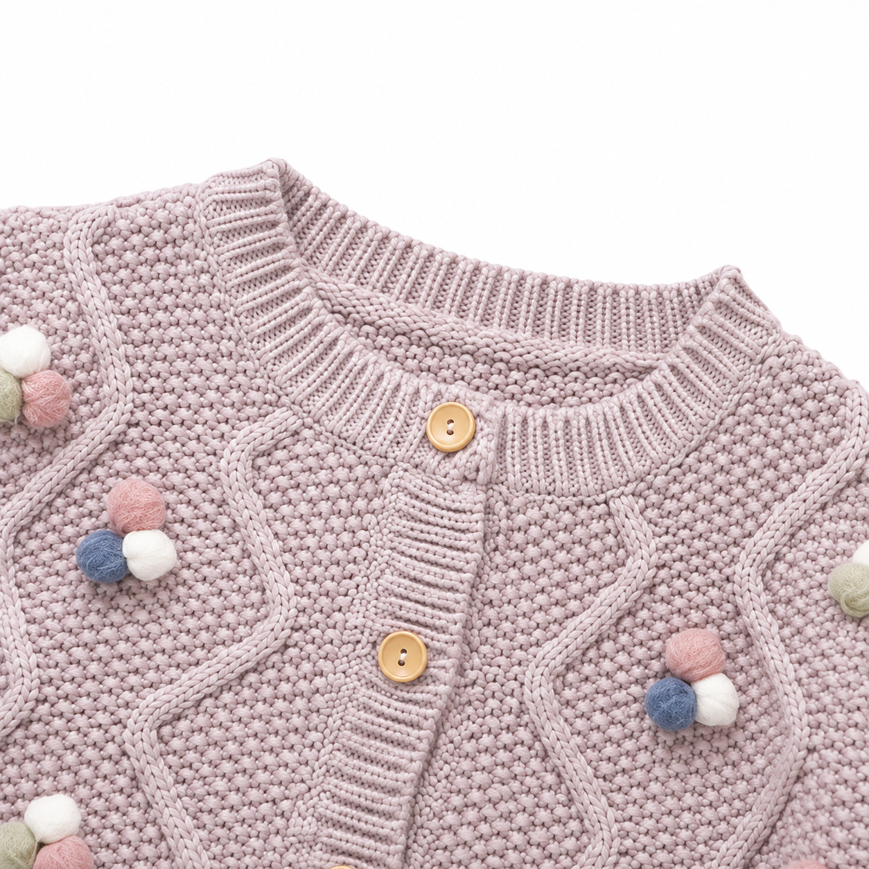 Close-up of the dusty mauve cardigan neckline, buttons, cable knit pattern, and pom blossom details.