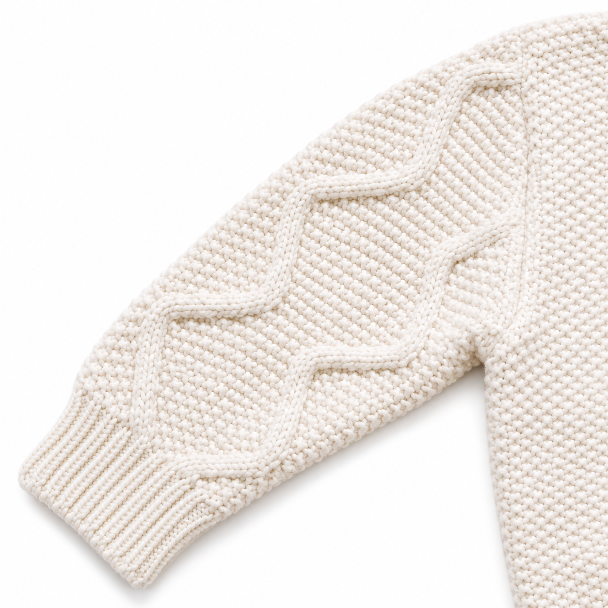 Close-up of the ivory cardigan sleeve with cable knit texture and ribbed cuff.