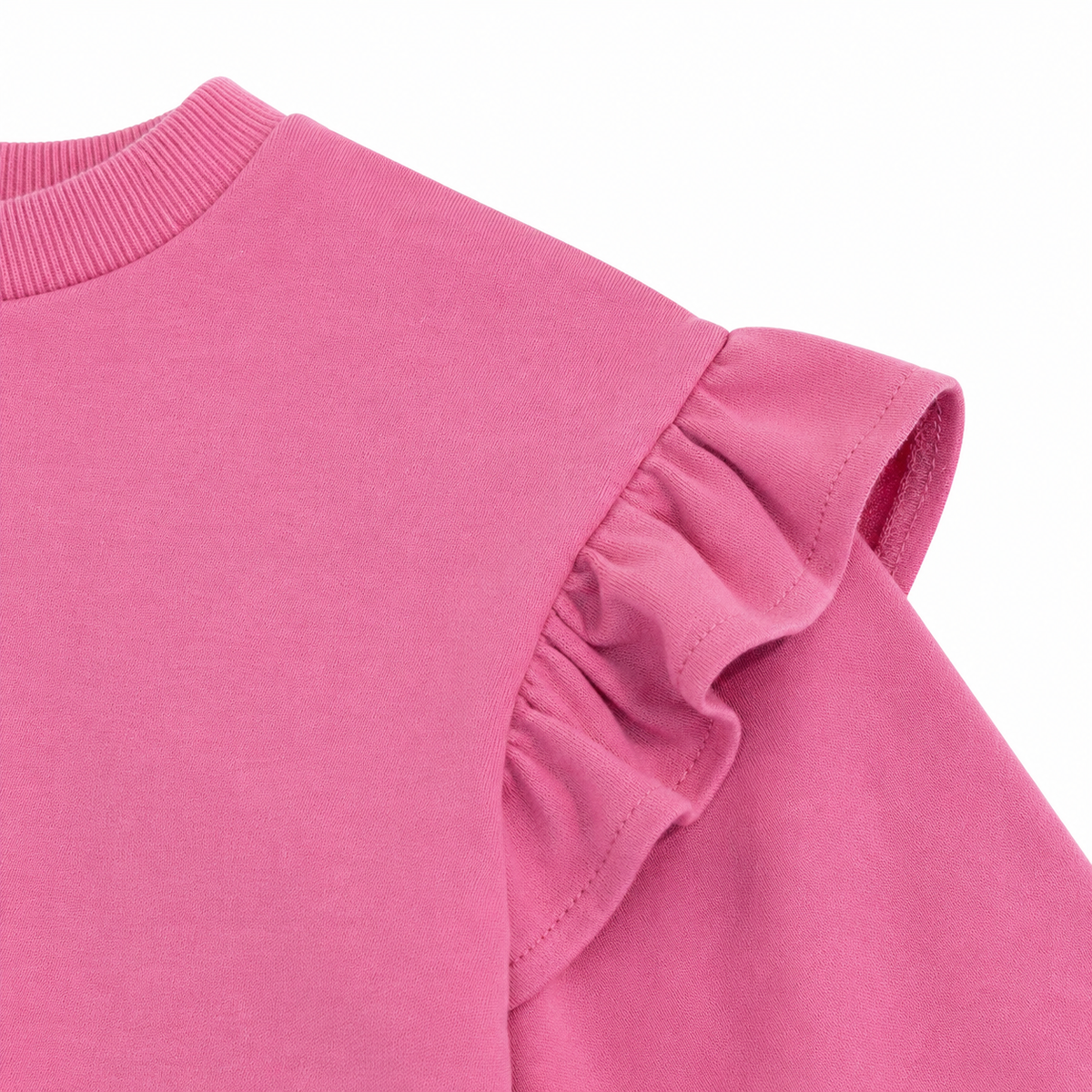 Close-up of the layered ruffle shoulder detail on the bright pink sweatshirt.