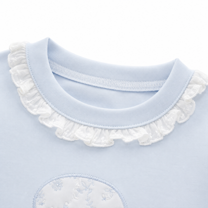 Close-up of the ruffle-trim crew neckline on the Powder Blue girls cotton long sleeve top.