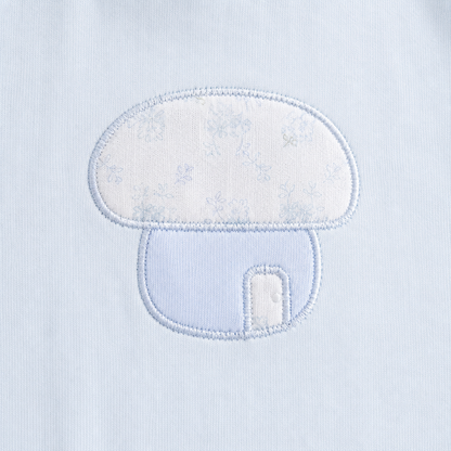 Close-up of the mushroom embroidery on the Powder Blue girls cotton long sleeve top.