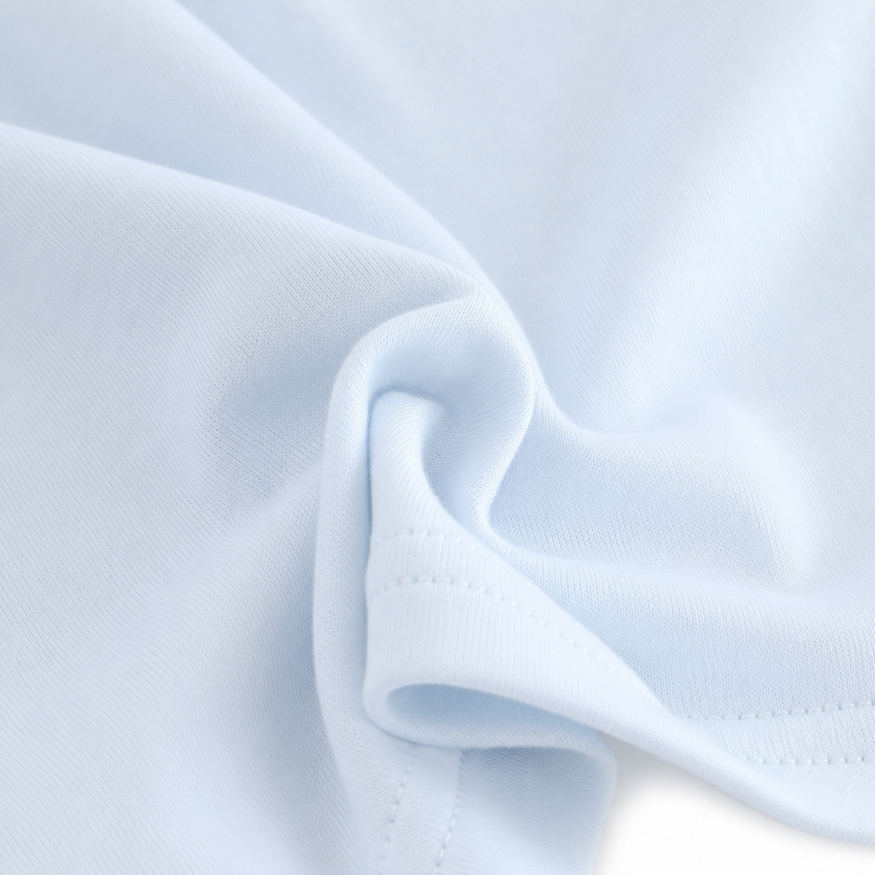 Close-up of the cotton fabric and construction detail on the Powder Blue girls long sleeve top.