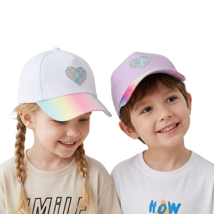 Kids wearing Rainbow Heart Baseball Cap in white and lavender with glitter rainbow brim.