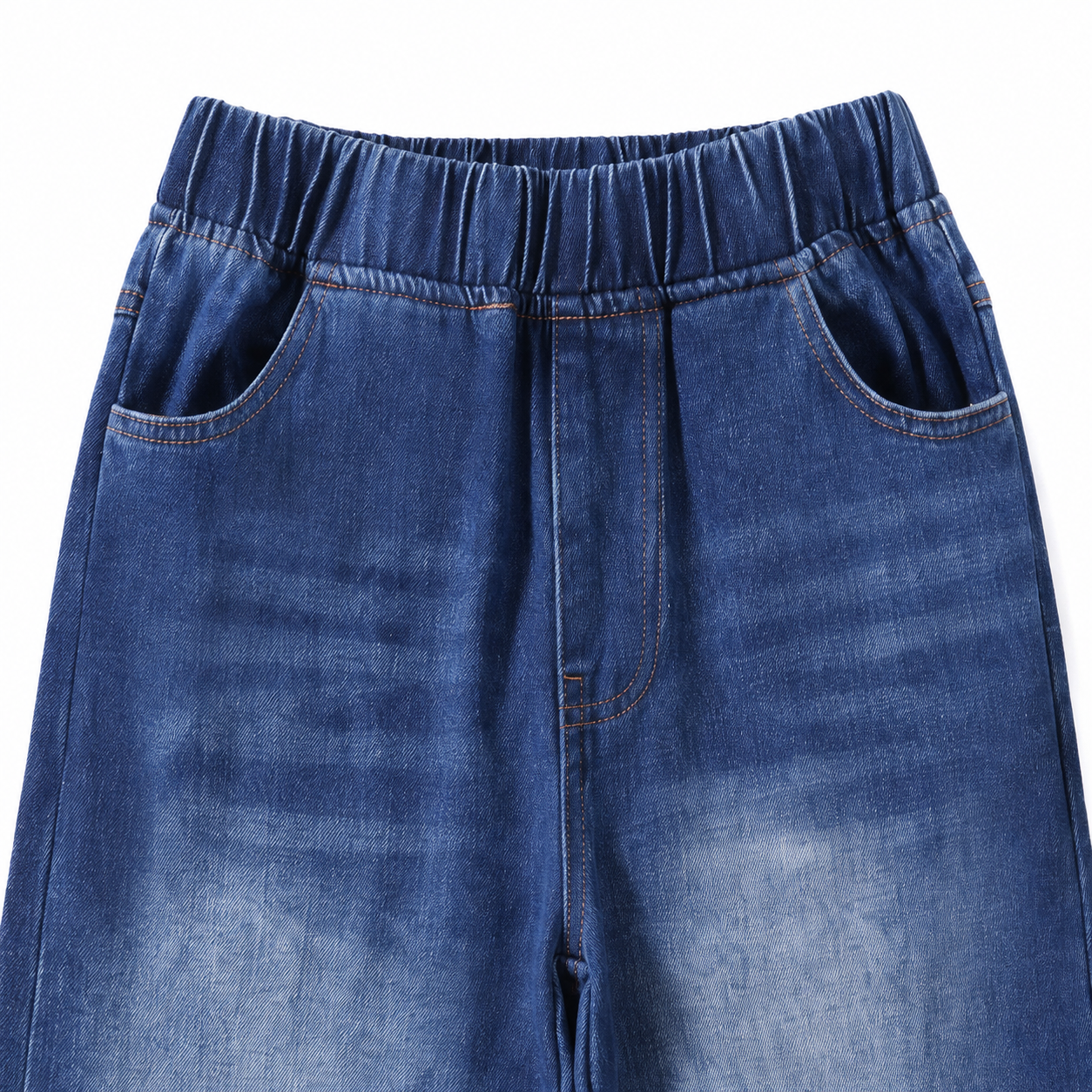 Close-up of the elastic waistband, front pockets, and medium blue denim wash.