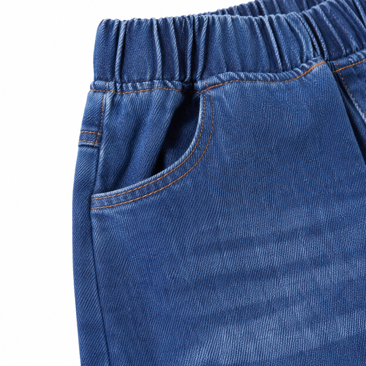 Close-up of the front pocket, waistband stitching, and faded denim detail.