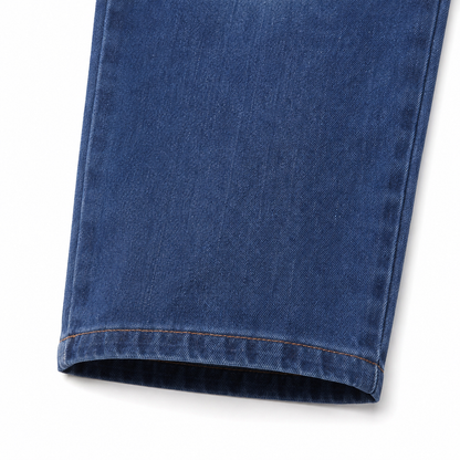 Close-up of the straight-leg hem on the medium blue kids jeans.