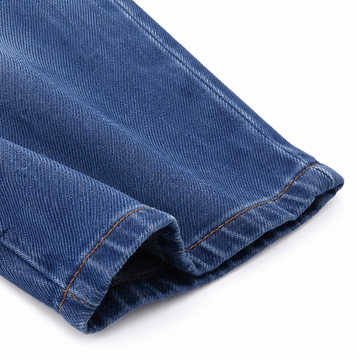 Close-up of the denim fabric, seam stitching, and finished leg opening.