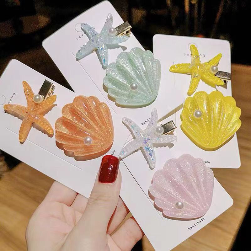 Seaside Pearl Hair Clip Set featuring colorful shell and starfish hair clips with pearl accents.