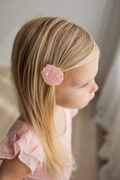 Seaside Pearl Hair Clip Set pink shell hair clip with pearl detail worn by a young girl.