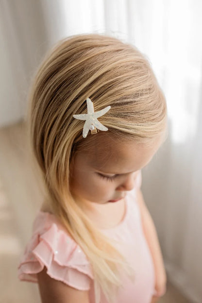 Seaside Pearl Hair Clip Set starfish clip worn by a young girl with blonde hair.