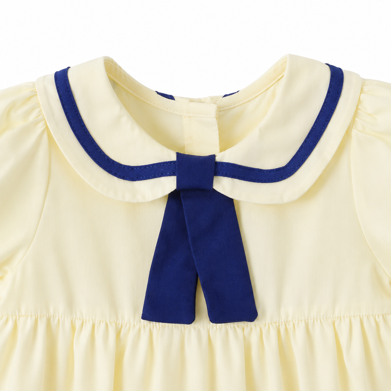 Close-up of the navy-trimmed sailor collar on the girls cotton dress.