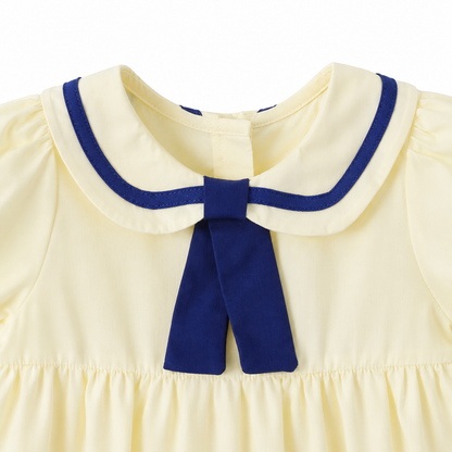 Close-up of the navy-trimmed sailor collar on the girls cotton dress.