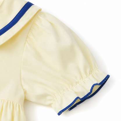 Close-up of the puff sleeve and navy trim detail on the sailor dress.