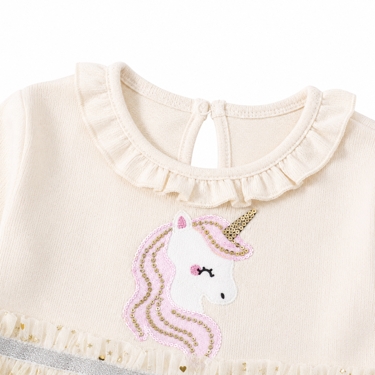 Close-up of the ruffle neckline and unicorn embroidery detail.