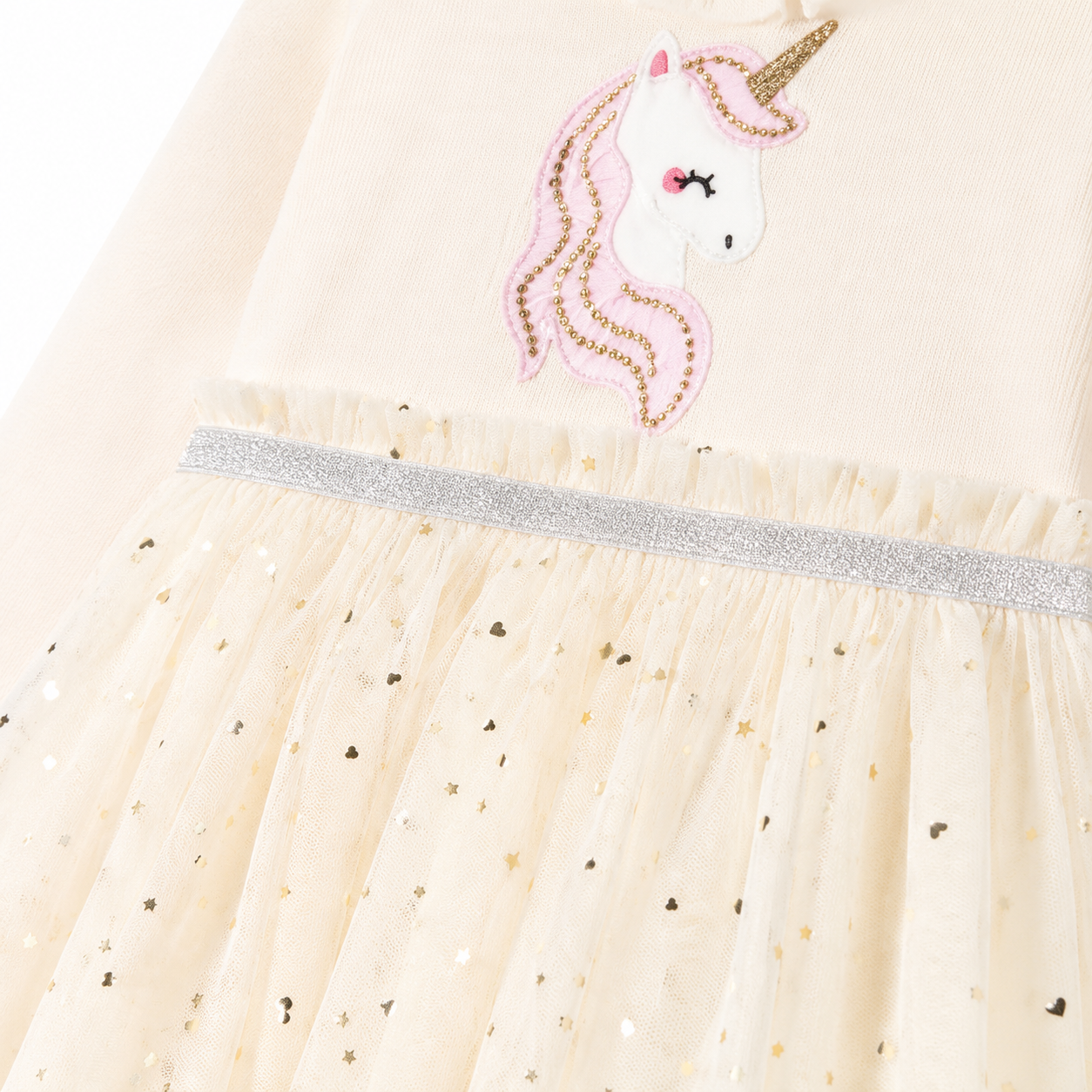 Close-up of the unicorn motif, silver waist trim, and dotted tulle overlay.