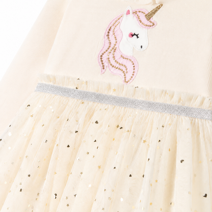 Close-up of the unicorn motif, silver waist trim, and dotted tulle overlay.