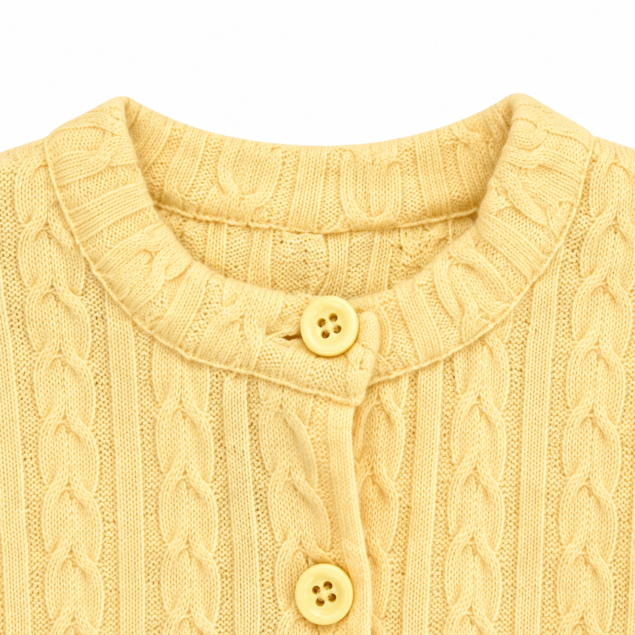 Close-up of the round neckline and button closure on the Butter Yellow cardigan.