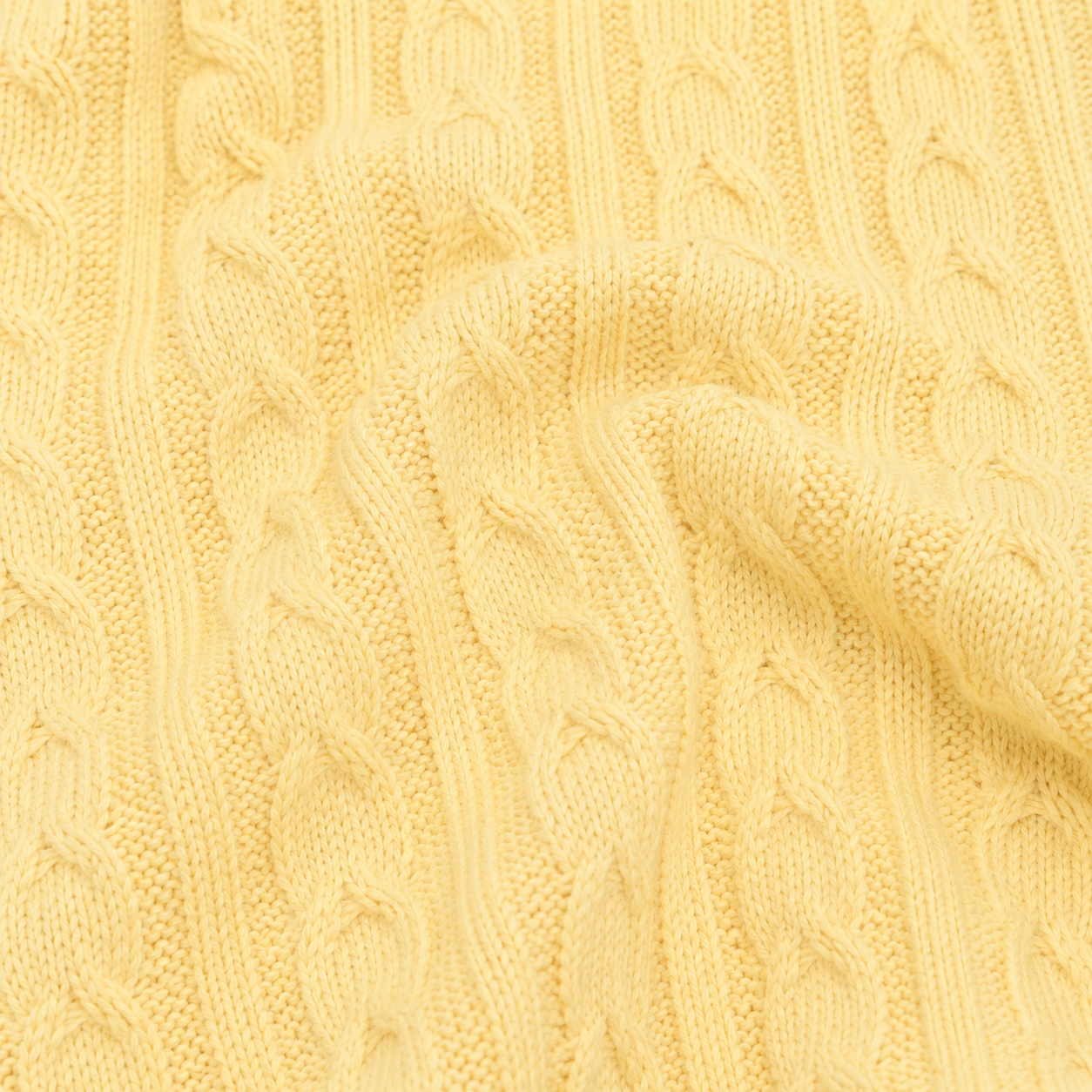 Close-up of the cable-knit cotton texture on the Butter Yellow cardigan.