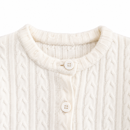 Close-up of the round neckline and button closure on the Ivory cardigan.