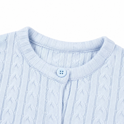 Close-up of the round neckline and button closure on the light blue cardigan.