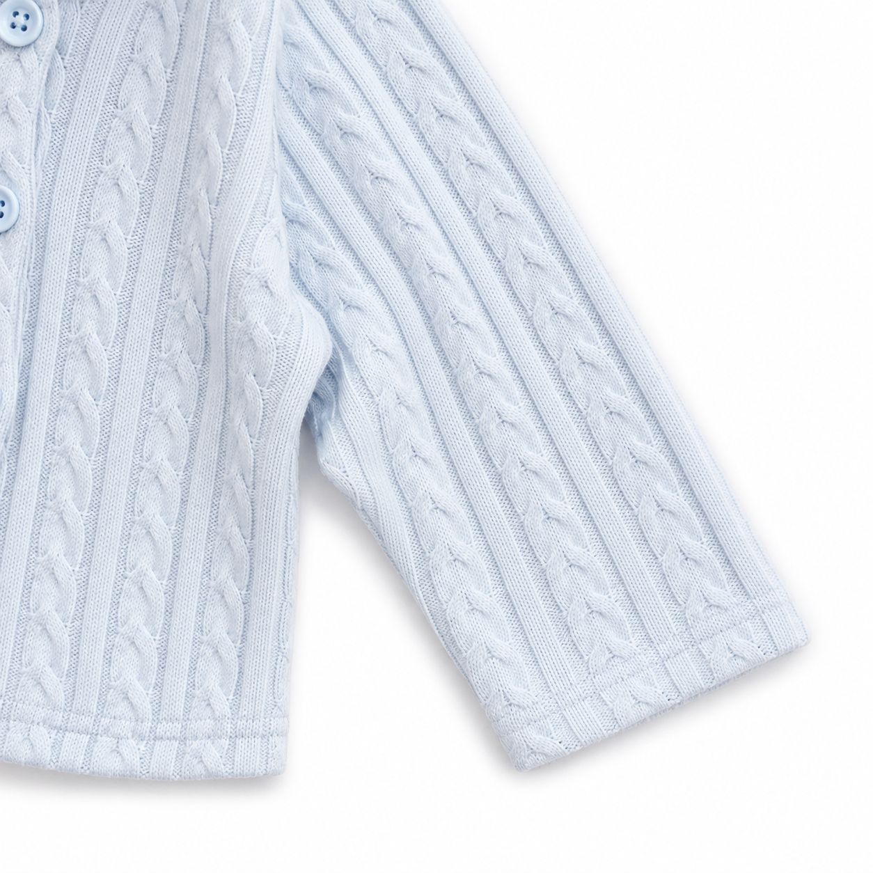 Close-up of the long sleeve and knit cuff on the light blue cardigan.