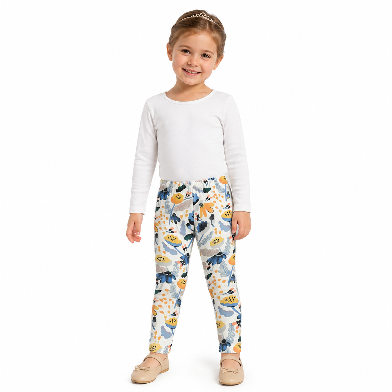 Girl model wearing the ivory floral cotton pants with an elastic waist.