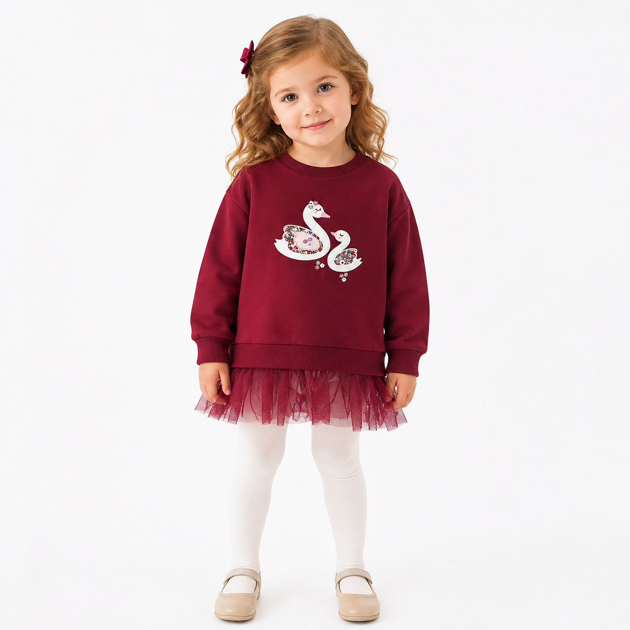 Girl model wearing the burgundy swan applique sweatshirt with tulle hem.