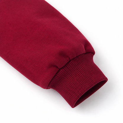 Close-up of the ribbed cuff on the burgundy long sleeve sweatshirt.