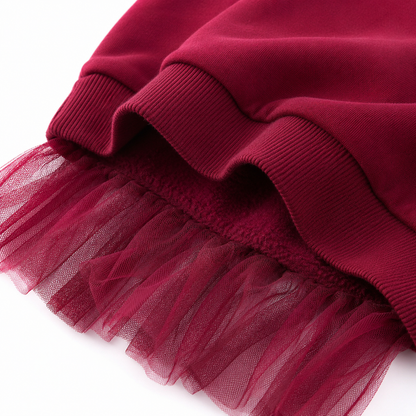 Close-up of the ribbed hem and burgundy tulle overlay detail.