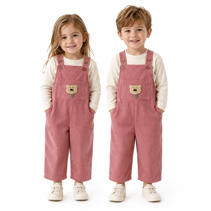 Girl and boy child models wearing the dusty rose kids corduroy bib overalls.