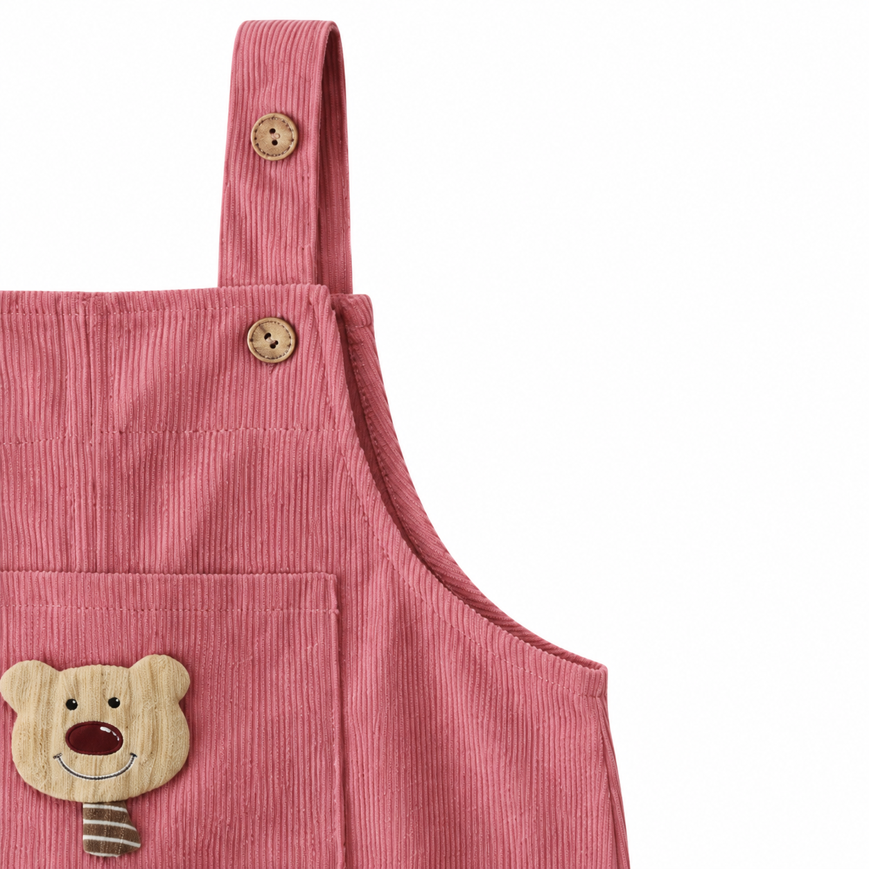 Close-up of the upper bib and side seam detail on the dusty rose overalls.