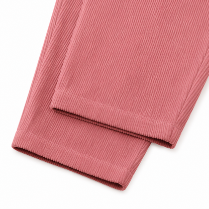 Close-up of the corduroy texture and pant leg hem on the dusty rose overalls.